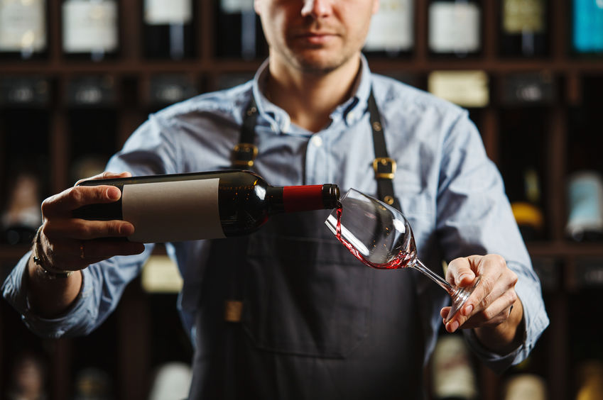 Bartender pouring wine